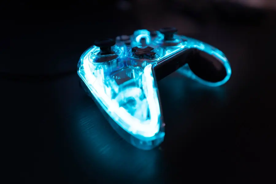 A glowing see-through game controller on a dark table